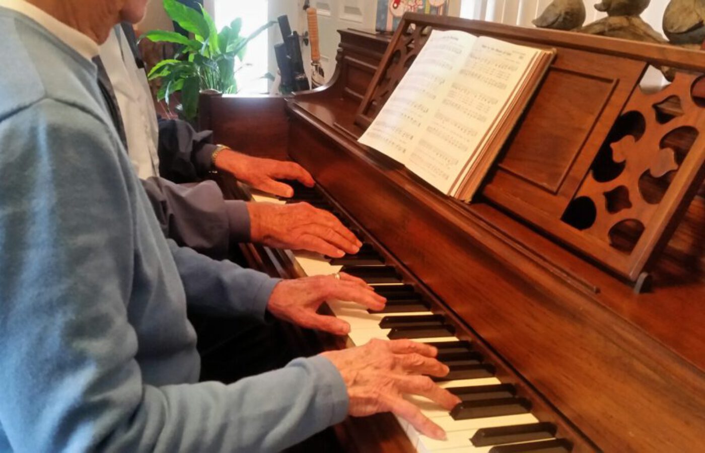 hands-on-piano-playing-music-together-as-seniors-v-ASHZ3LS