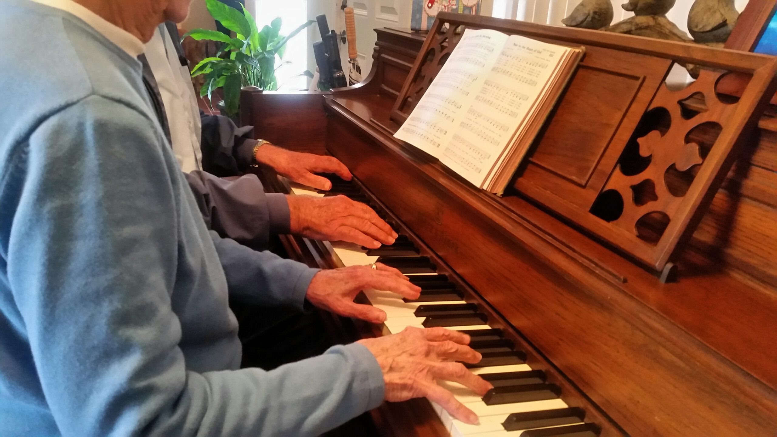 hands-on-piano-playing-music-together-as-seniors-v-ASHZ3LS